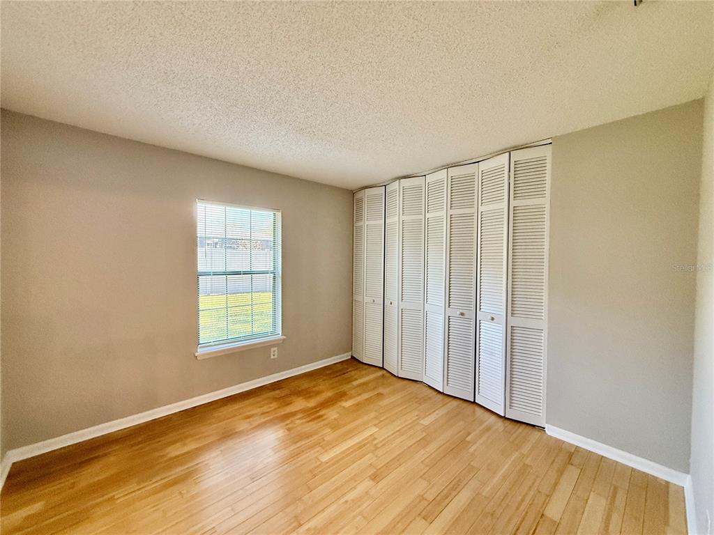 758 Warrenton Road Winter Park, FL 32792 - Photo 18 of 52 a view of an empty room with wooden floor and a window