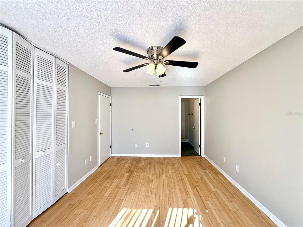 758 Warrenton Road Winter Park, FL 32792 - Photo 30 of 52 an empty room with a ceiling fan and wooden floor