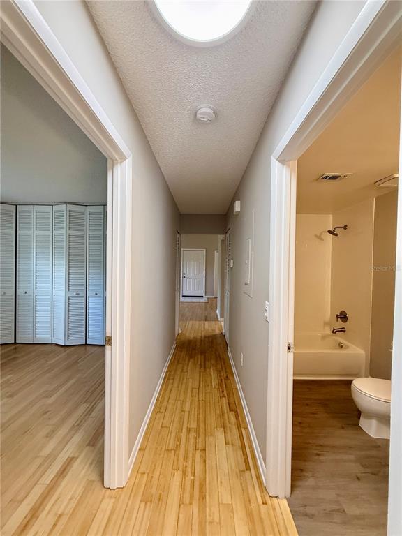 758 Warrenton Road Winter Park, FL 32792 - Photo 37 of 52 a view of a hallway with wooden floor and a bathroom