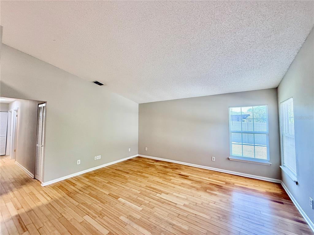 758 Warrenton Road Winter Park, FL 32792 - Photo 4 of 52 wooden floor in an empty room with a window