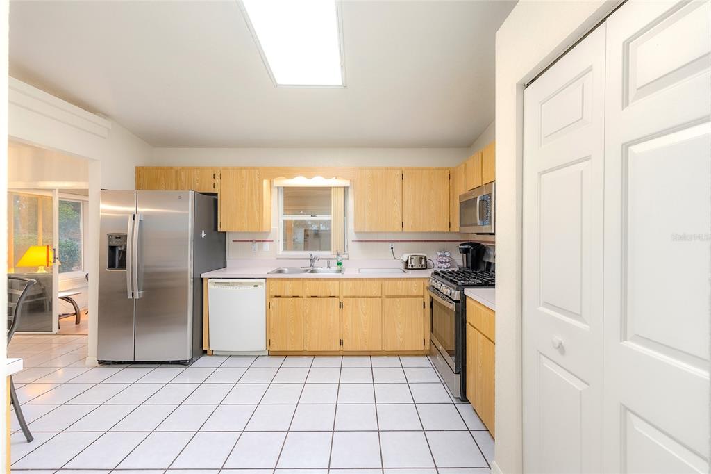 4513 Southwest 158th St Road Ocala, FL 34473 - Photo 17 of 41 a kitchen with stainless steel appliances granite countertop a refrigerator and a stove top oven