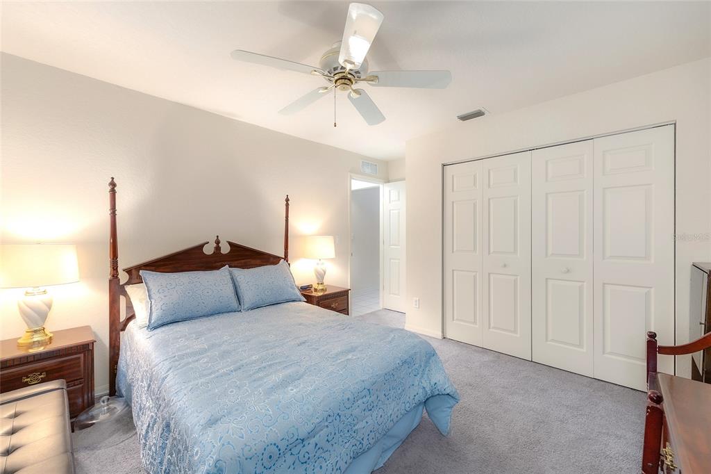 4513 Southwest 158th St Road Ocala, FL 34473 - Photo 24 of 41 a bedroom with a bed and a chandelier