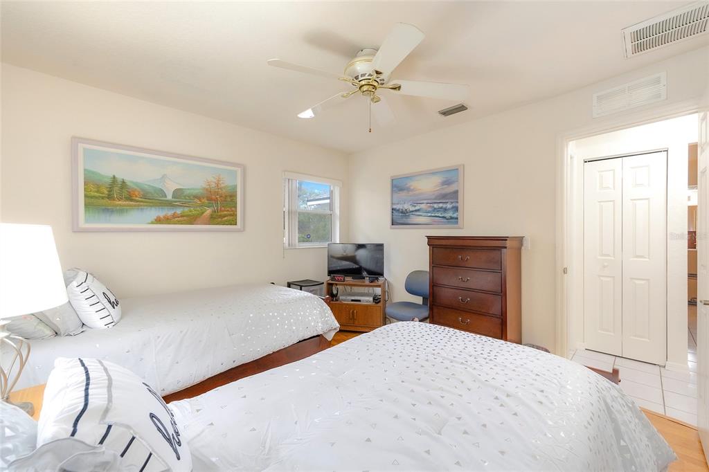 4513 Southwest 158th St Road Ocala, FL 34473 - Photo 27 of 41 a bedroom with furniture and a chandelier