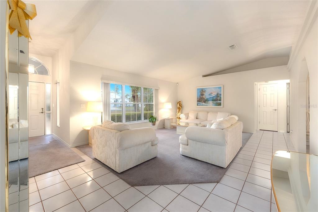 4513 Southwest 158th St Road Ocala, FL 34473 - Photo 7 of 41 a living room with furniture and a large window