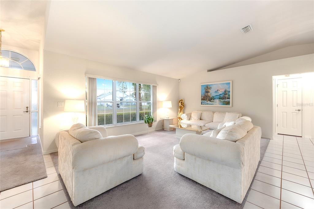 4513 Southwest 158th St Road Ocala, FL 34473 - Photo 8 of 41 a living room with furniture and a large window