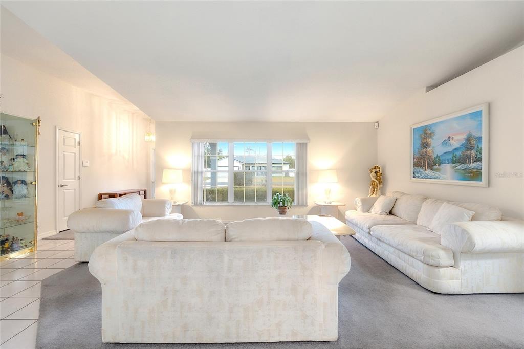 4513 Southwest 158th St Road Ocala, FL 34473 - Photo 9 of 41 a living room with furniture and a large window