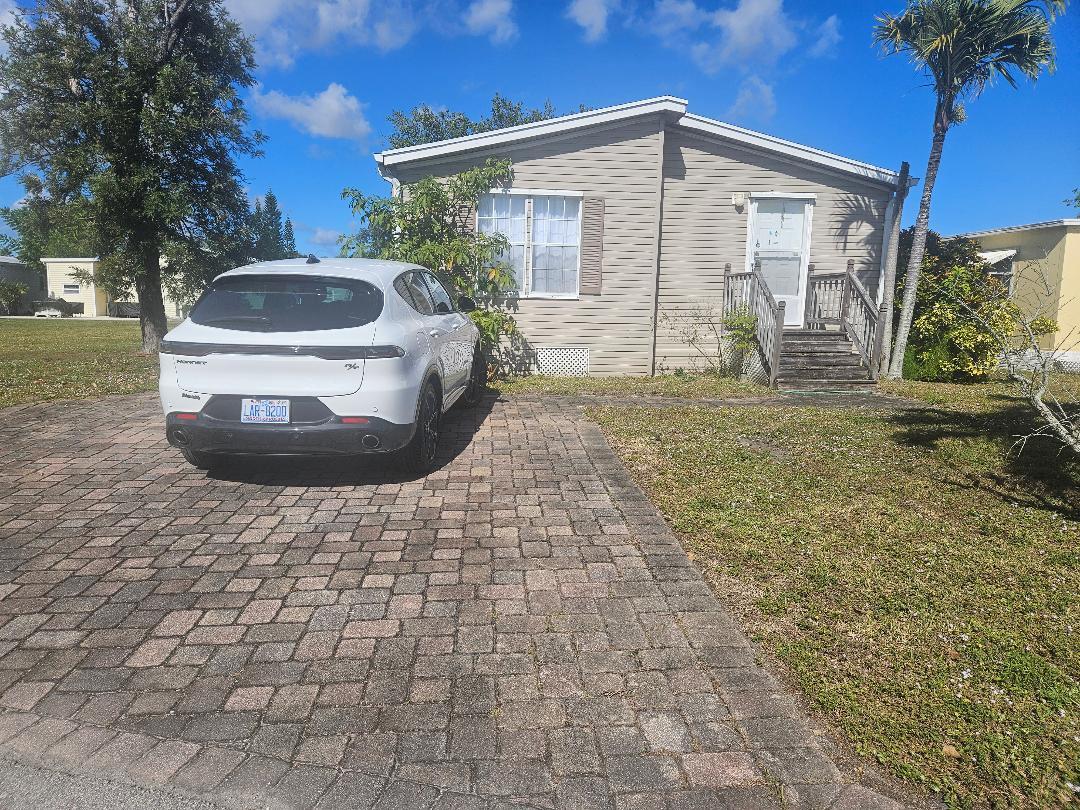 a view of a house with a yard and garage