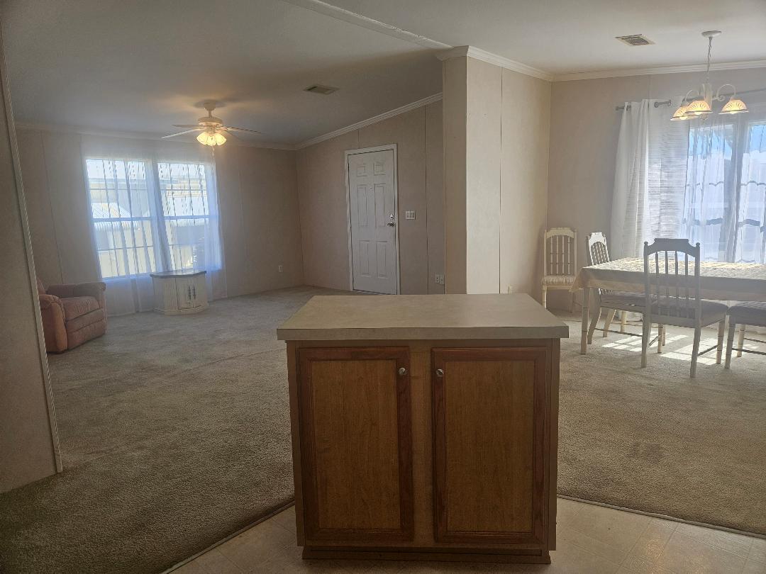 4317 71st Street North, Unit 1277 Riviera Beach, FL 33404 - Photo 11 of 19 a view of kitchen with furniture and window