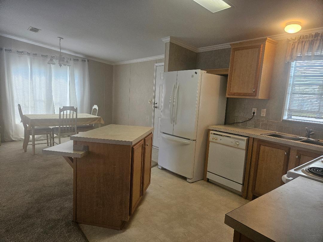 4317 71st Street North, Unit 1277 Riviera Beach, FL 33404 - Photo 3 of 19 a kitchen with a refrigerator sink stove and cabinets