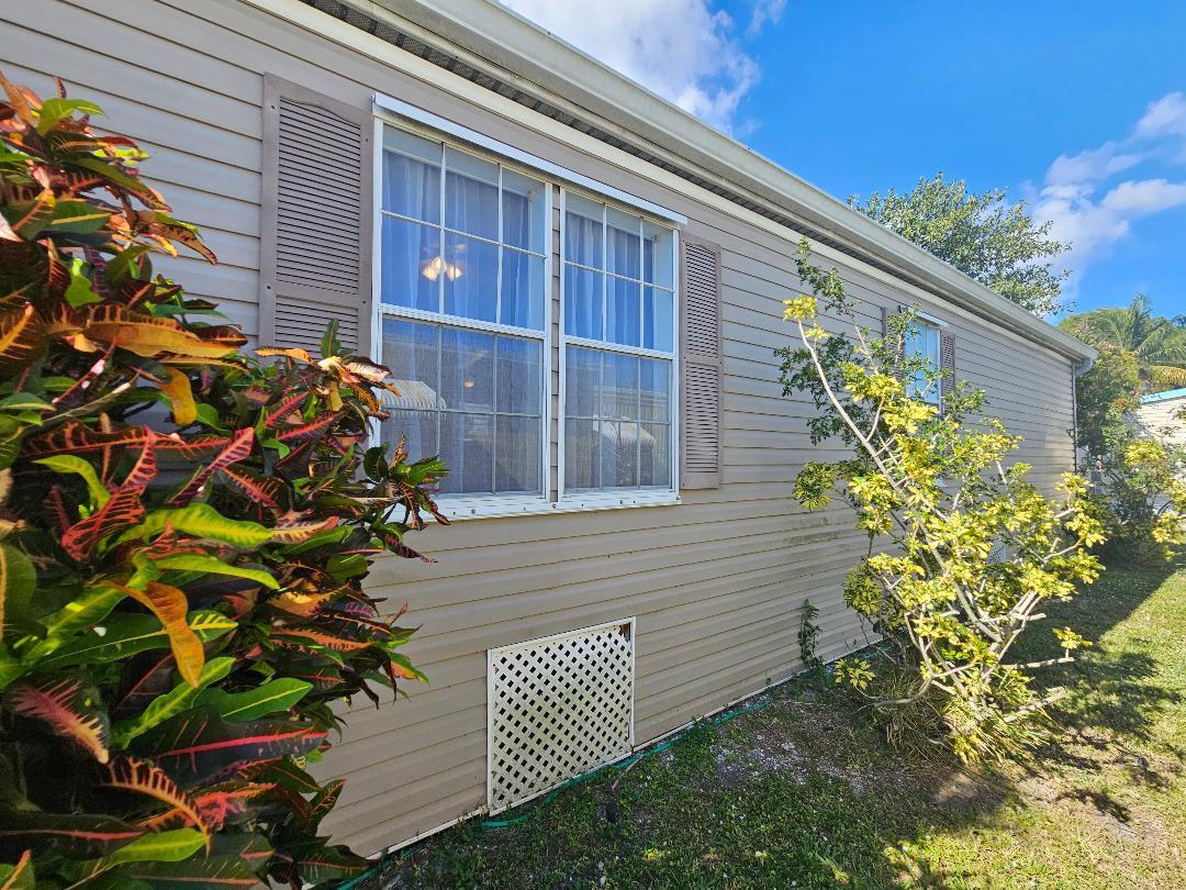 4317 71st Street North, Unit 1277 Riviera Beach, FL 33404 - Photo 7 of 19 a front view of a house with a garden