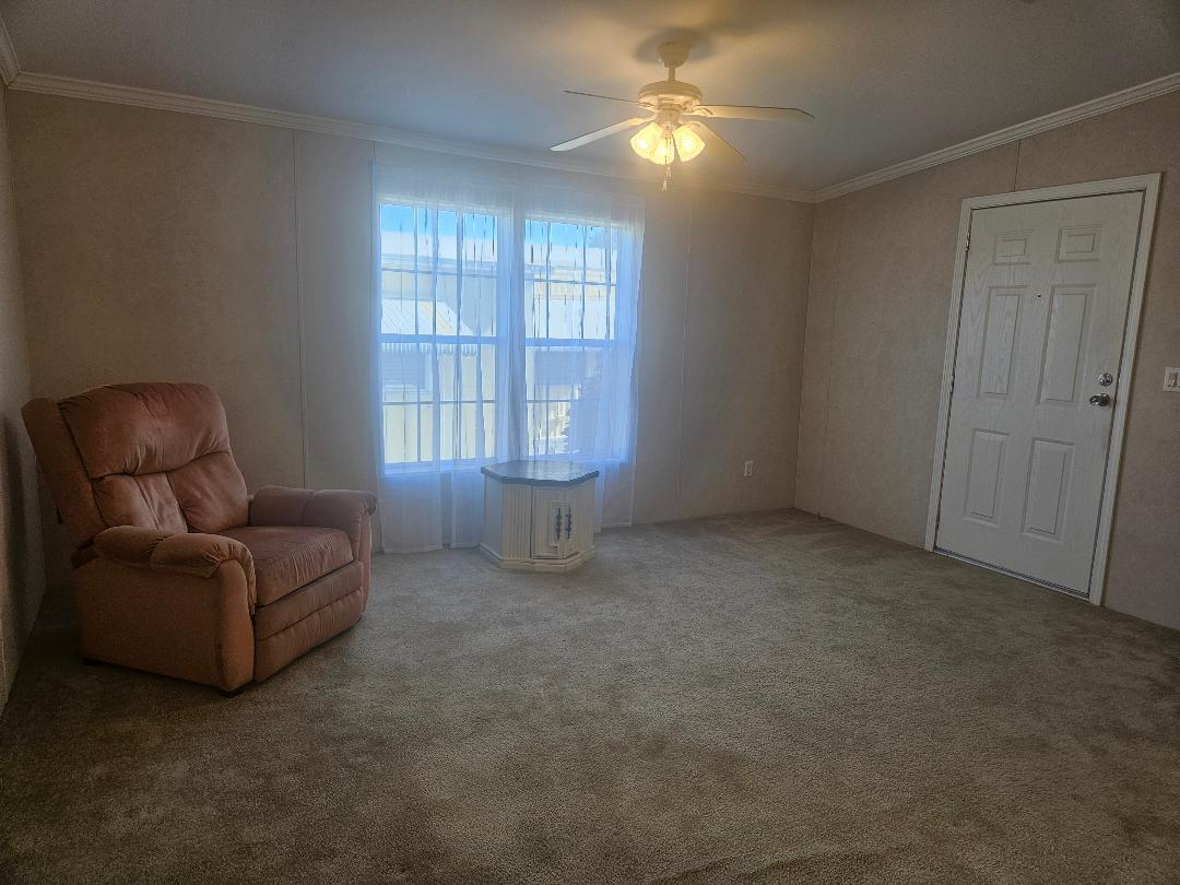 4317 71st Street North, Unit 1277 Riviera Beach, FL 33404 - Photo 10 of 19 a living room with furniture and a ceiling fan