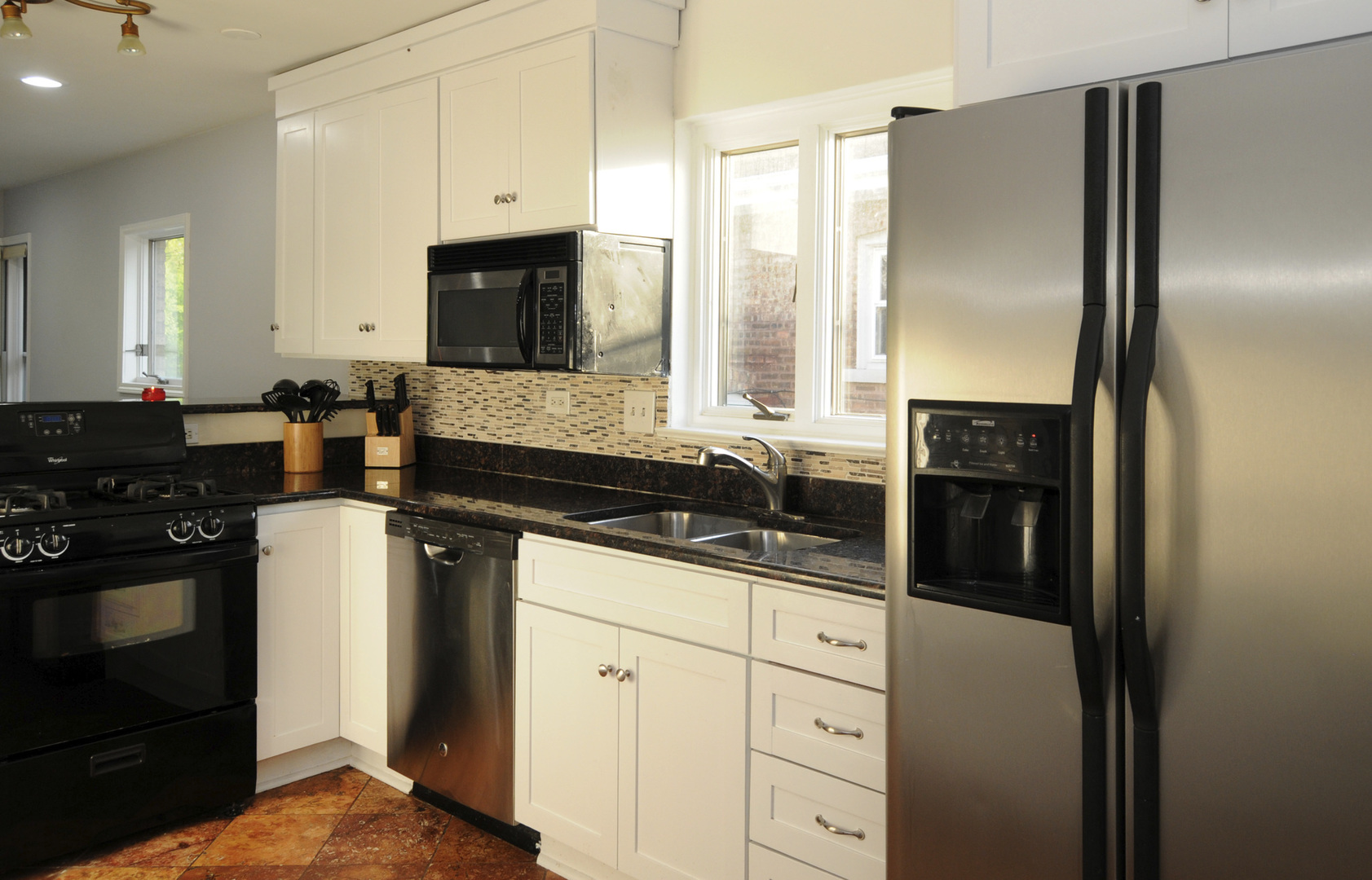 9038 South Forestview Drive North Riverside, IL 60546 - Photo 7 of 24 a kitchen with stainless steel appliances granite countertop a refrigerator a stove and a sink