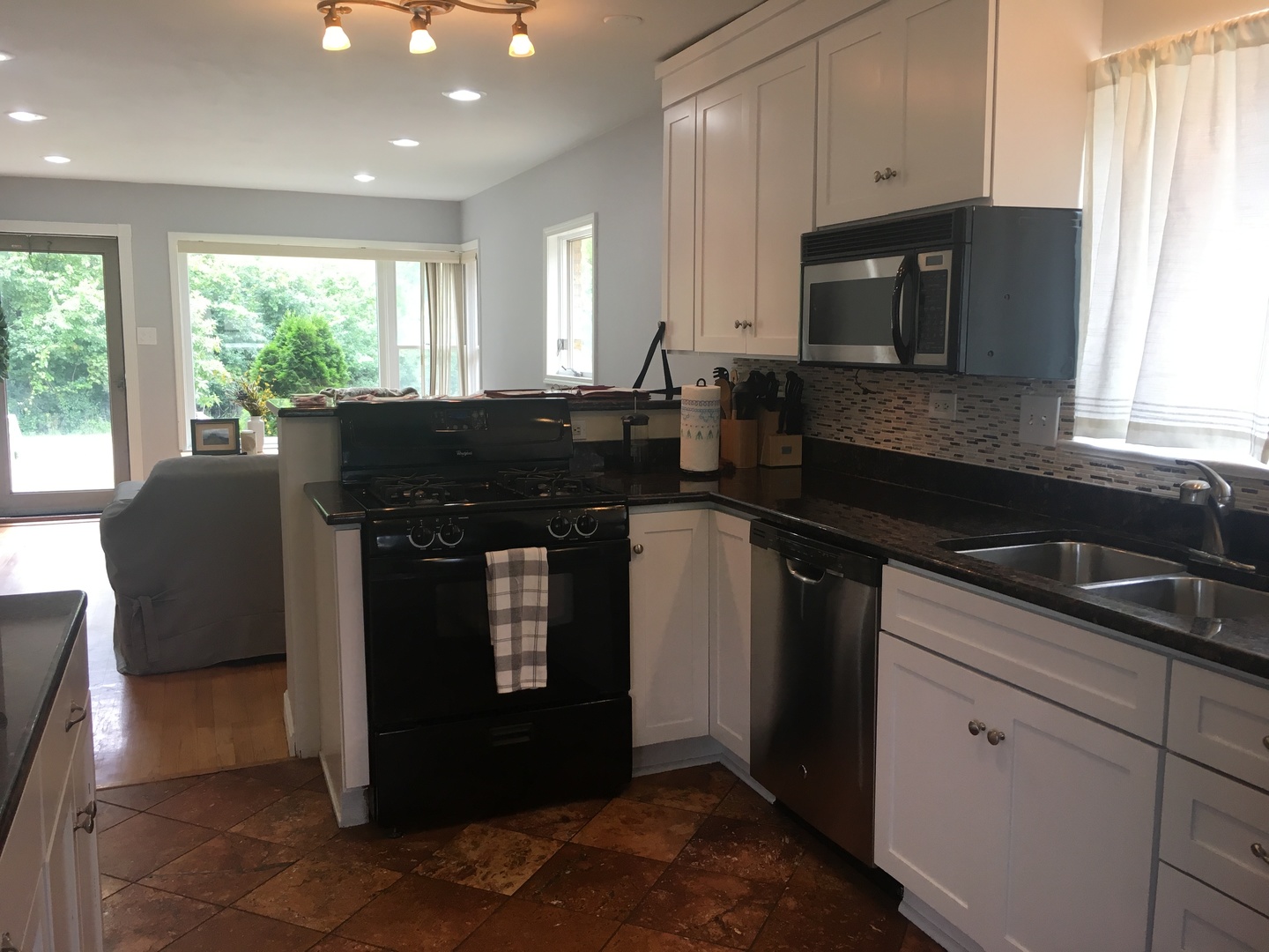 9038 South Forestview Drive North Riverside, IL 60546 - Photo 8 of 24 a kitchen with stainless steel appliances granite countertop a stove a sink and a microwave
