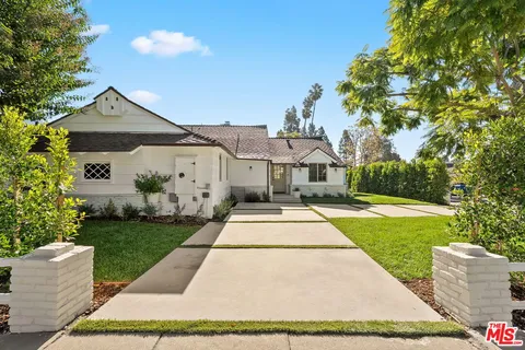 a front view of a house with yard