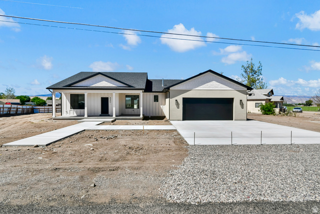 840 South Jones Road Monroe, UT 84754 - Photo 33 of 52 Single-story residence featuring a covered front porch with columns, a two-car garage, and a concrete driveway
