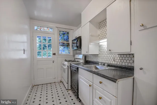 a kitchen with a sink stove and cabinets