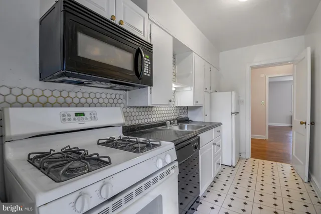 a kitchen with a stove and a microwave