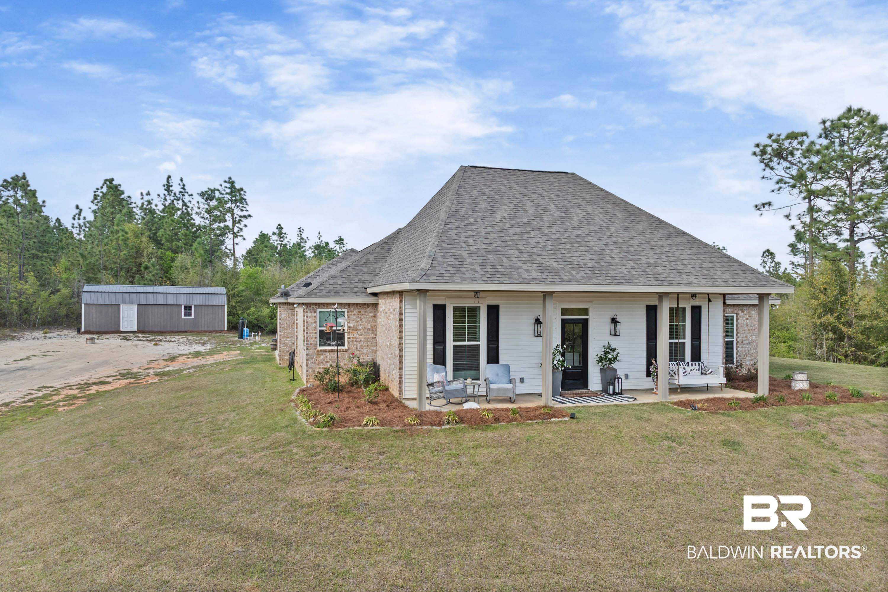 7150 Powell Road, Unit LOT 6A Eight Mile, AL 36613 - Photo 1 of 35 View of front of home with roof with shingles, a front lawn, an outdoor structure, and brick siding