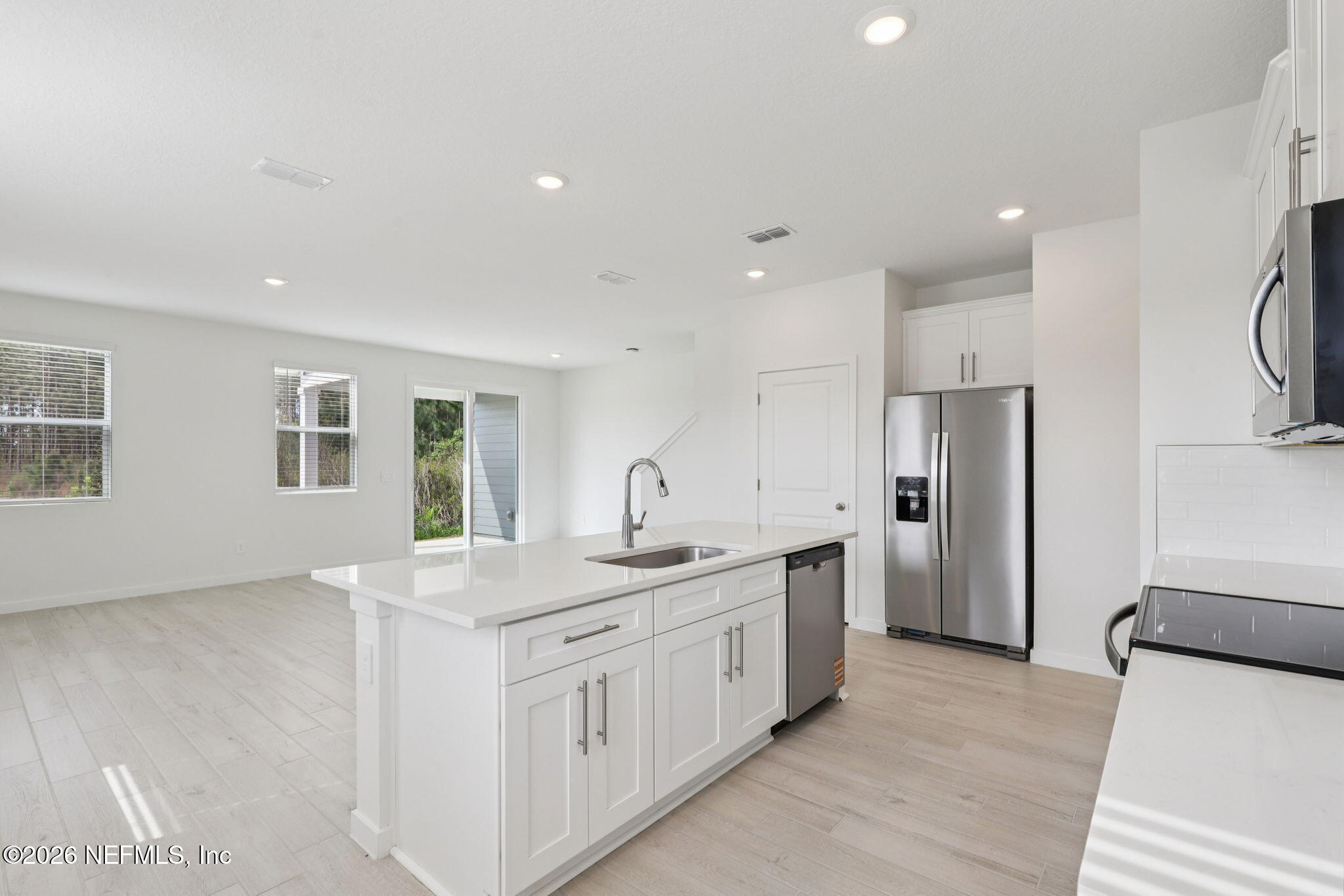 25 Rangeline Drive St. Augustine, FL 32092 - Photo 5 of 43 a kitchen with stainless steel appliances granite countertop a sink and a refrigerator