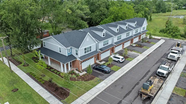 an aerial view of a house with a garden and trees