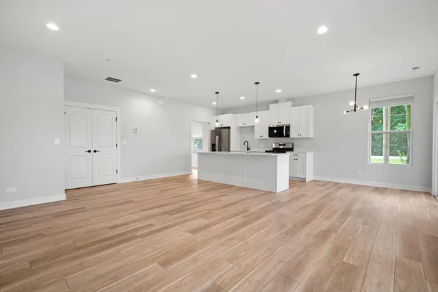 a view of kitchen with wooden floor and electronic appliances