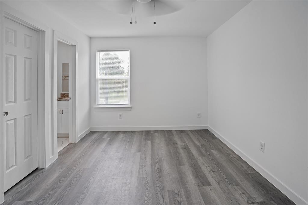 9313 Hillis Street, Unit A Houston, TX 77028 - Photo 11 of 14 wooden floor in an empty room with a window