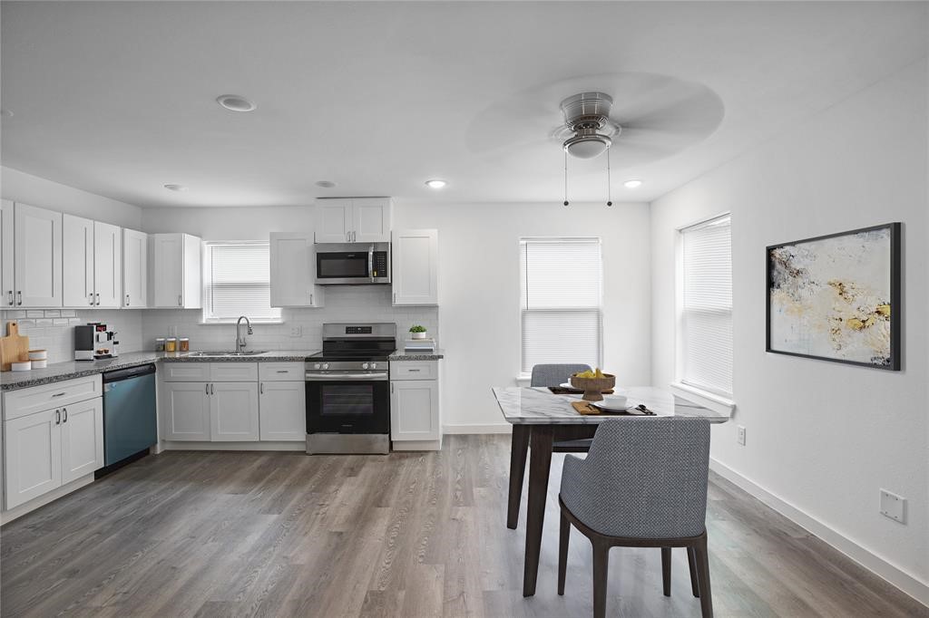 9313 Hillis Street, Unit A Houston, TX 77028 - Photo 2 of 14 a kitchen with granite countertop a stove top oven a sink dishwasher a dining table and chairs with wooden floor