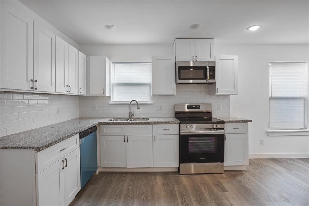 9313 Hillis Street, Unit A Houston, TX 77028 - Photo 3 of 14 a kitchen with stainless steel appliances granite countertop a stove and a sink