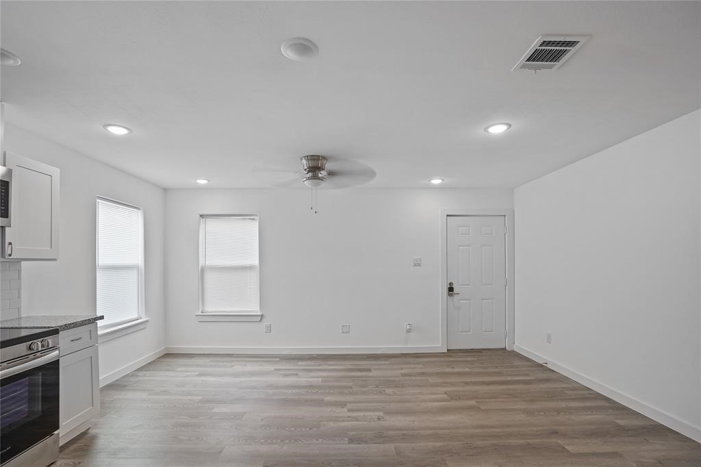 9313 Hillis Street, Unit A Houston, TX 77028 - Photo 4 of 14 an empty room with windows and cabinet
