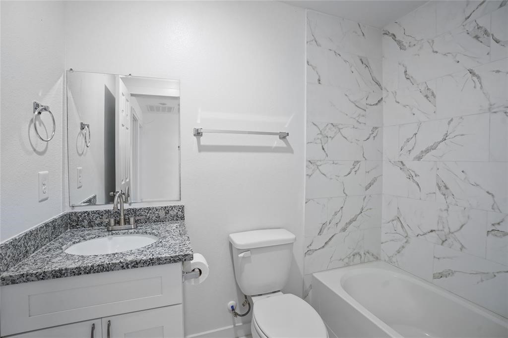 9313 Hillis Street, Unit A Houston, TX 77028 - Photo 8 of 14 a bathroom with a granite countertop sink toilet and shower