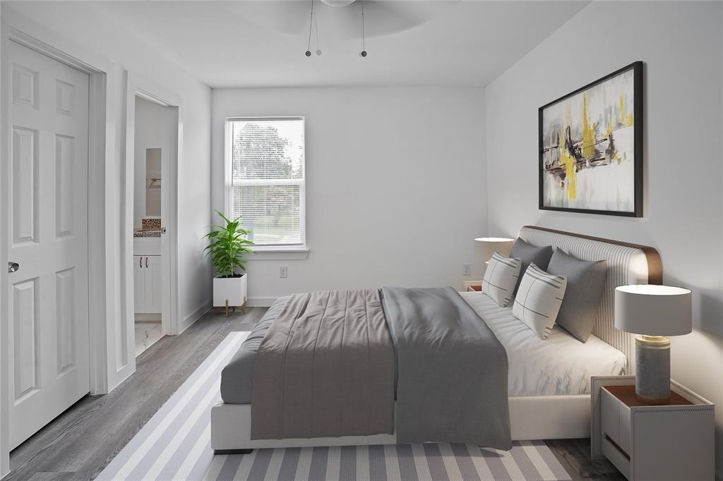 9313 Hillis Street, Unit A Houston, TX 77028 - Photo 9 of 14 a bedroom with a bed painting on wall and a potted plant