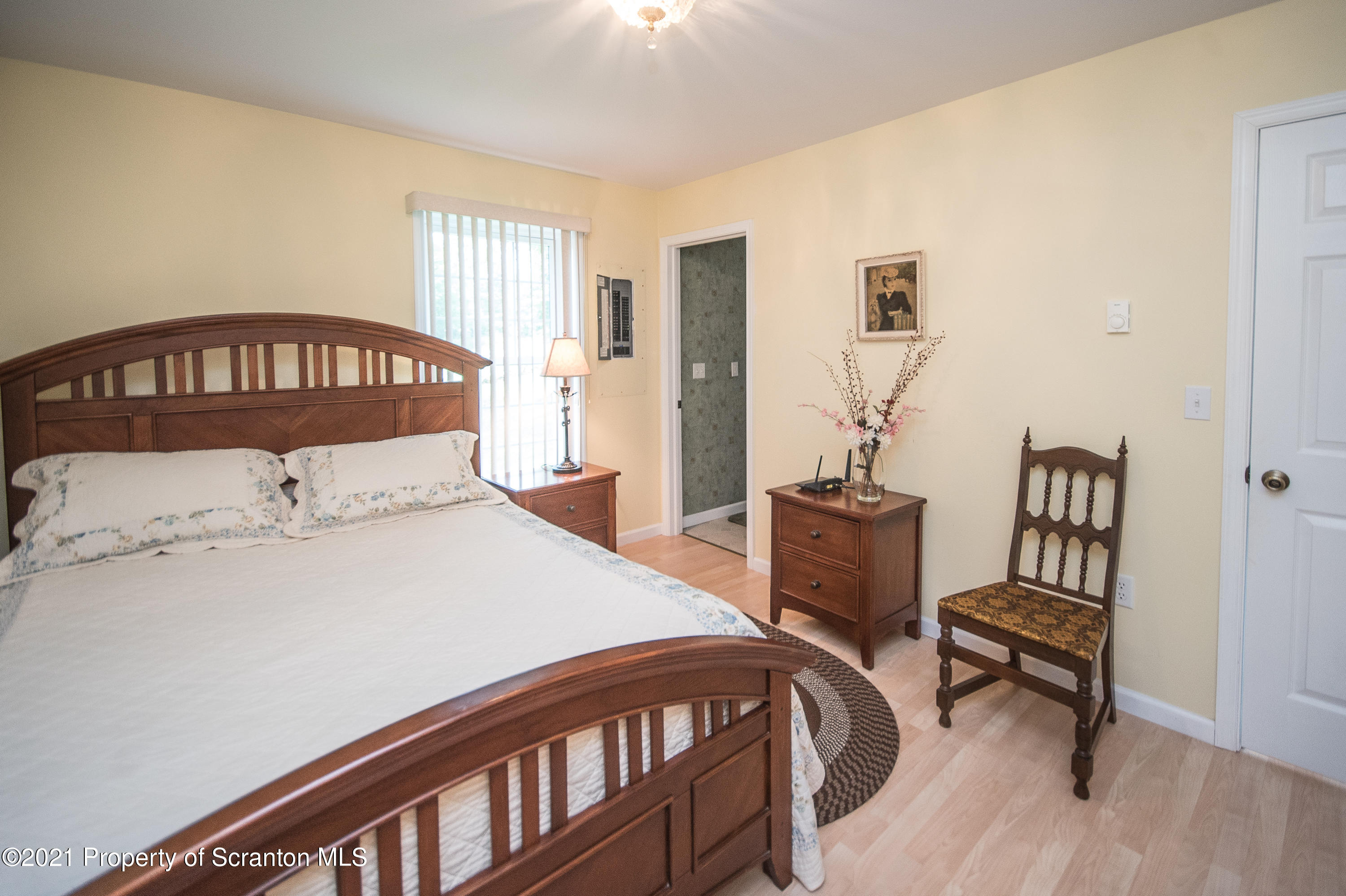 34 Taylor Farm Road Union Dale, PA 18470 - Photo 34 of 38 a bedroom with a bed and a chandelier