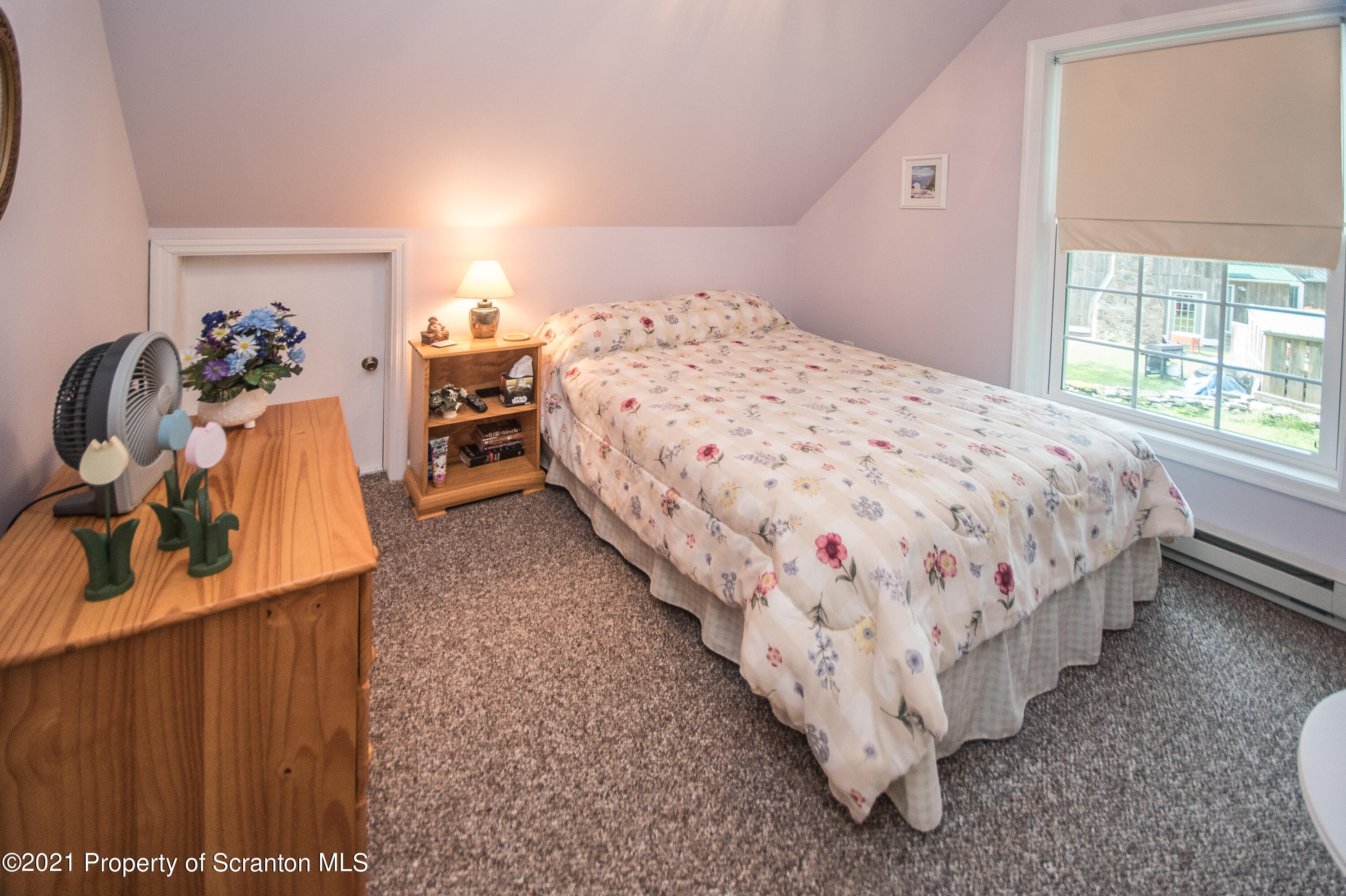 34 Taylor Farm Road Union Dale, PA 18470 - Photo 37 of 38 a bed sitting in a bedroom next to a window