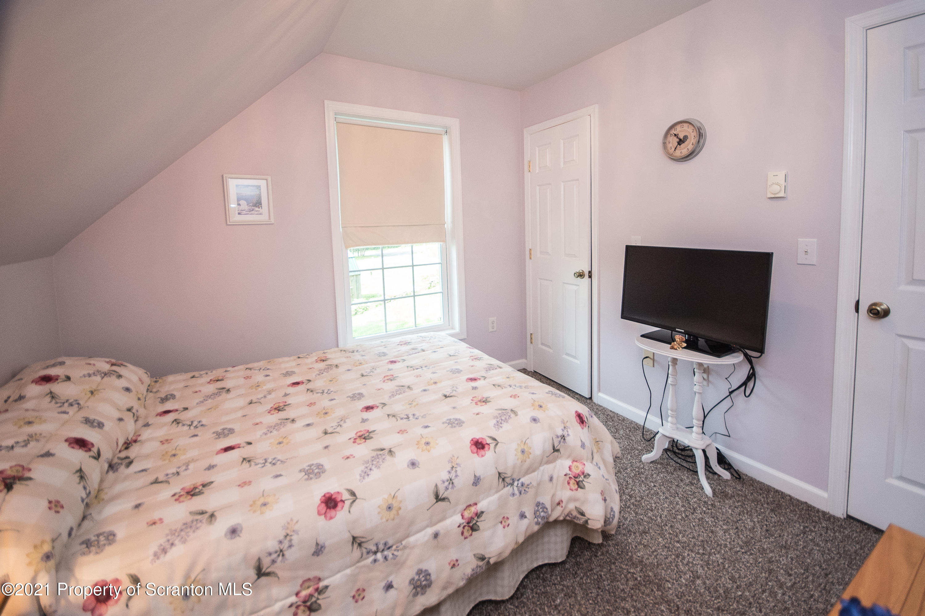 34 Taylor Farm Road Union Dale, PA 18470 - Photo 38 of 38 a bedroom with a bed and a flat screen tv