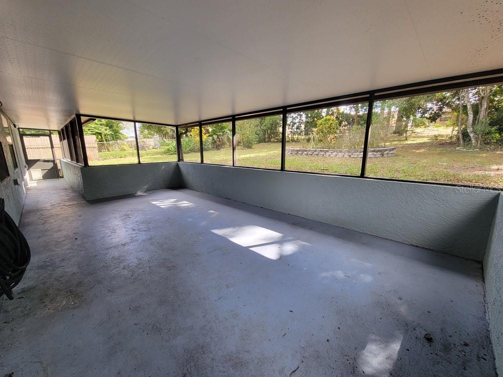 11633 Fox Run Port Richey, FL 34668 - Photo 30 of 33 a view of an empty room with a floor to ceiling window and an outdoor view