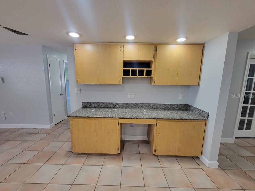 11633 Fox Run Port Richey, FL 34668 - Photo 10 of 33 a kitchen with stainless steel appliances granite countertop a sink and a refrigerator