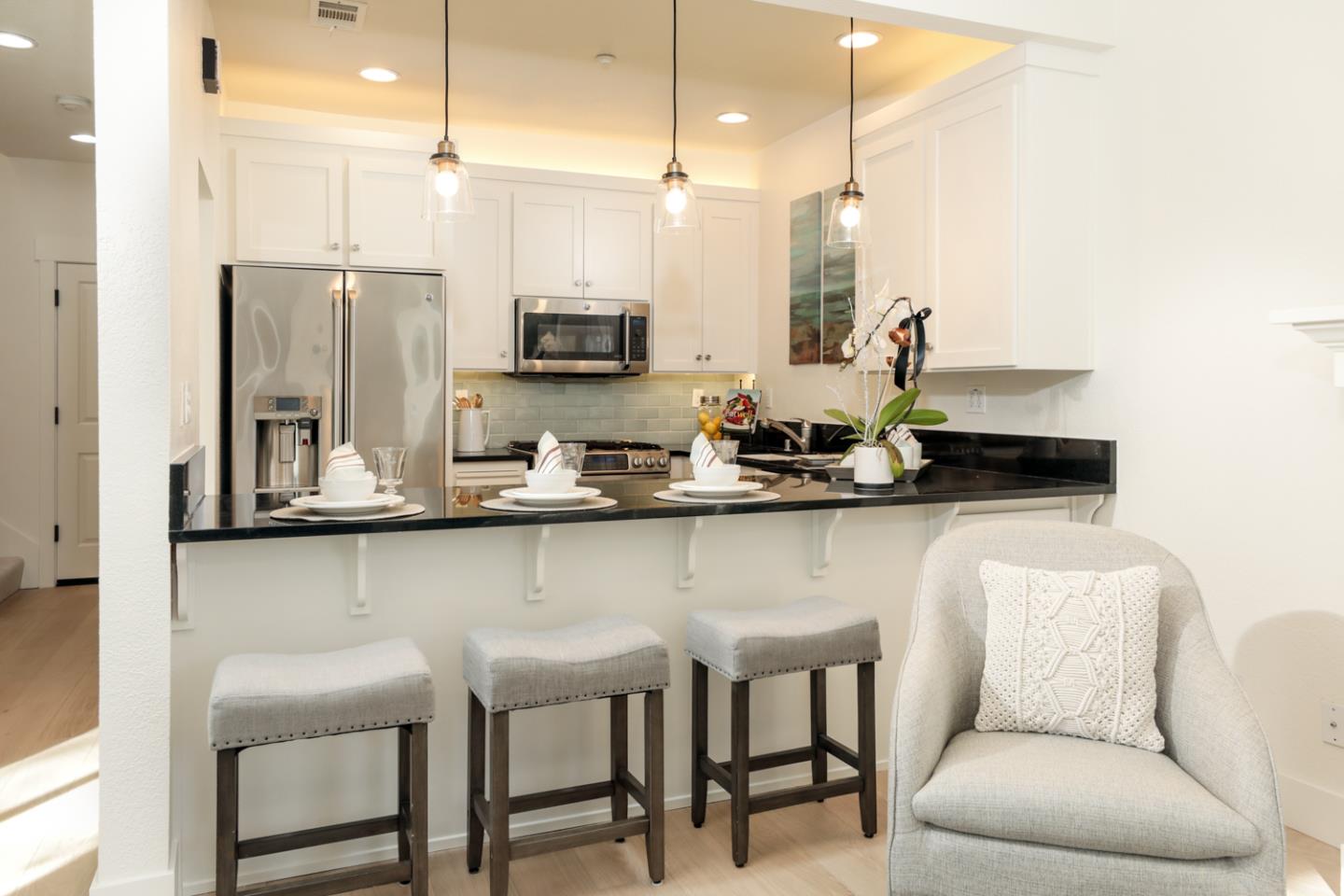 595 Willow Road Menlo Park, CA 94025 - Photo 11 of 28 a kitchen with stainless steel appliances kitchen island granite countertop a sink and cabinets