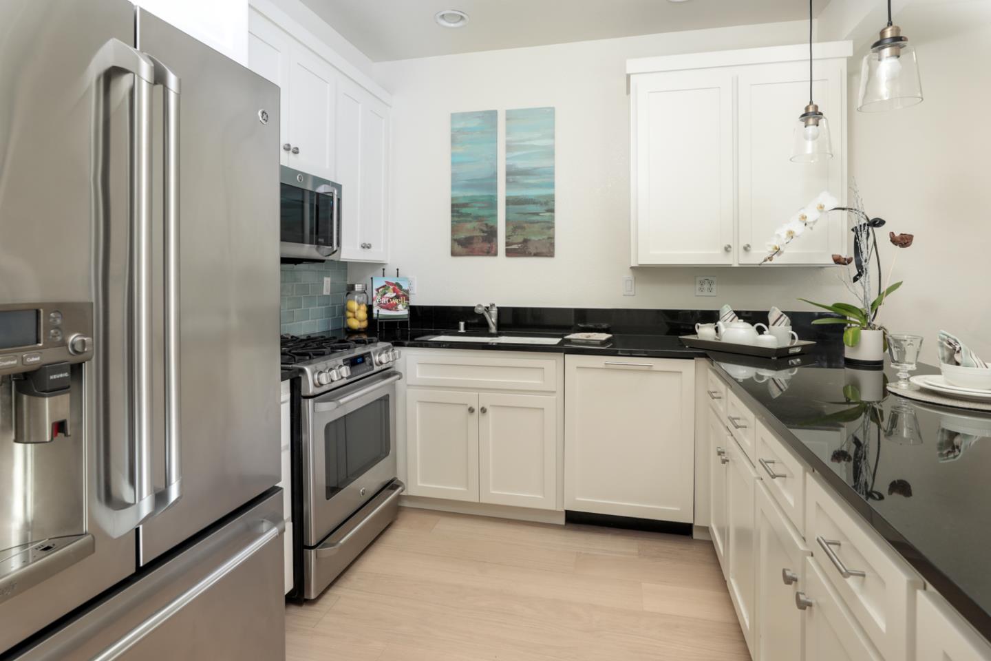 595 Willow Road Menlo Park, CA 94025 - Photo 12 of 28 a kitchen with a sink stove and refrigerator