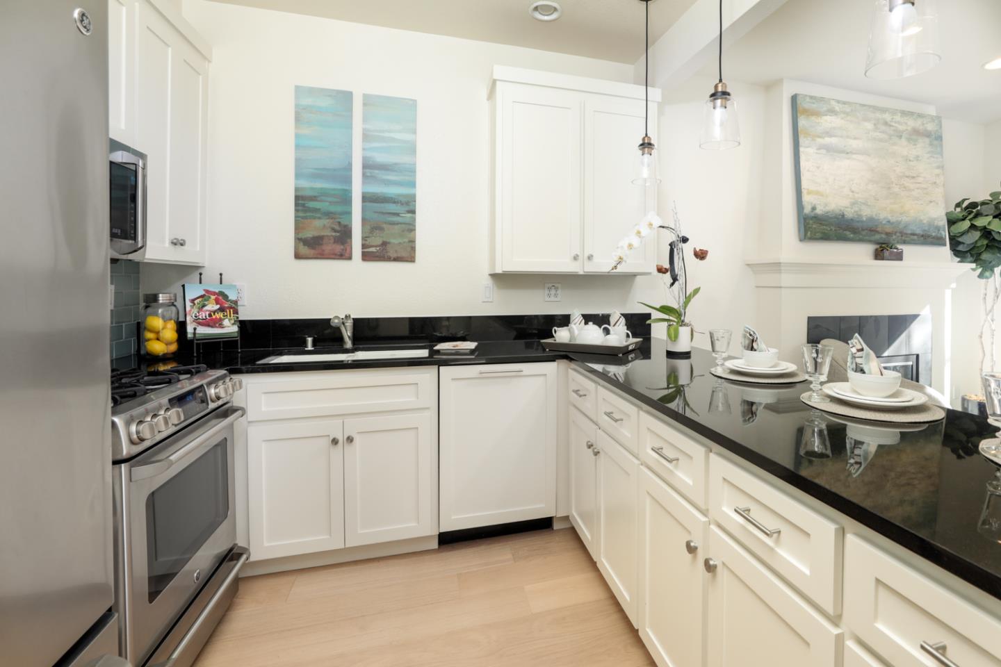 595 Willow Road Menlo Park, CA 94025 - Photo 13 of 28 a kitchen with a sink dishwasher stove and white cabinets