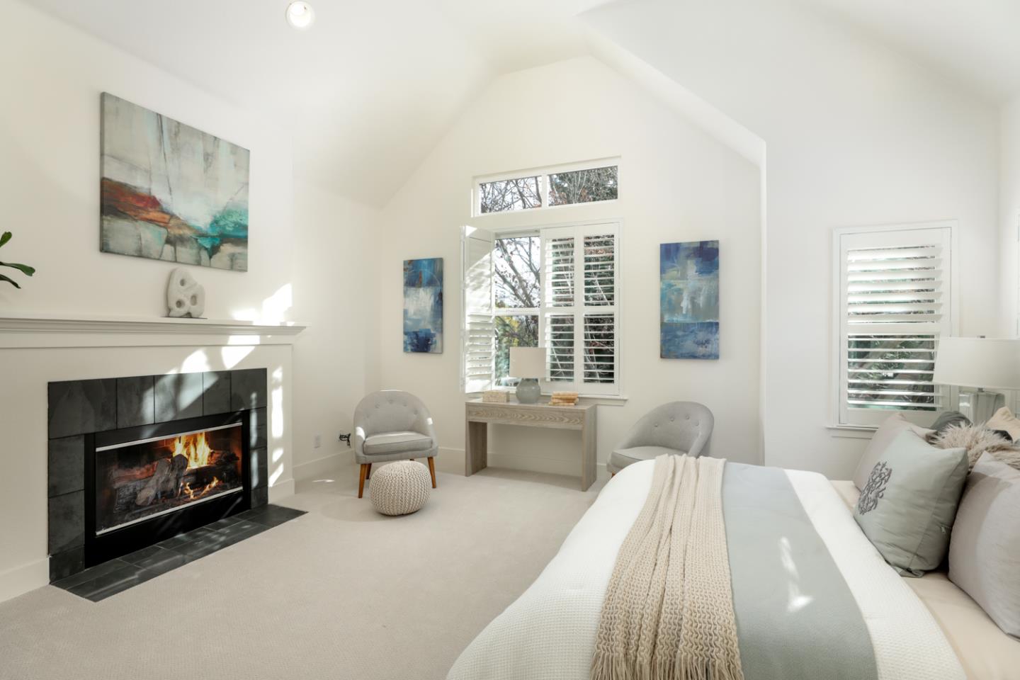 595 Willow Road Menlo Park, CA 94025 - Photo 19 of 28 a bedroom with a bed a fireplace and a large window