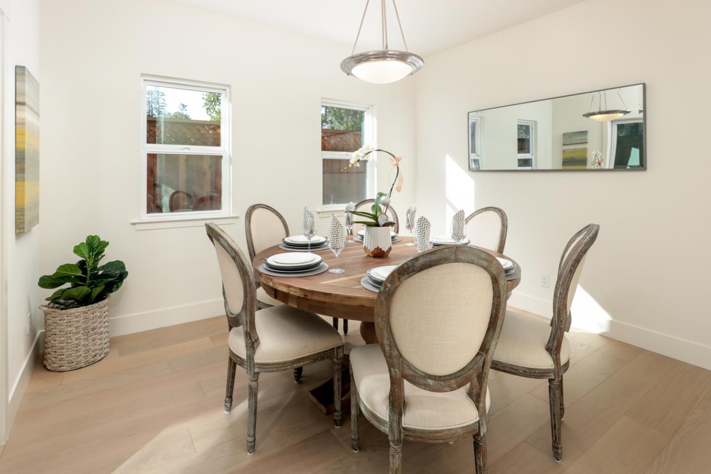 595 Willow Road Menlo Park, CA 94025 - Photo 5 of 28 a dining room with furniture potted plants and wooden floor