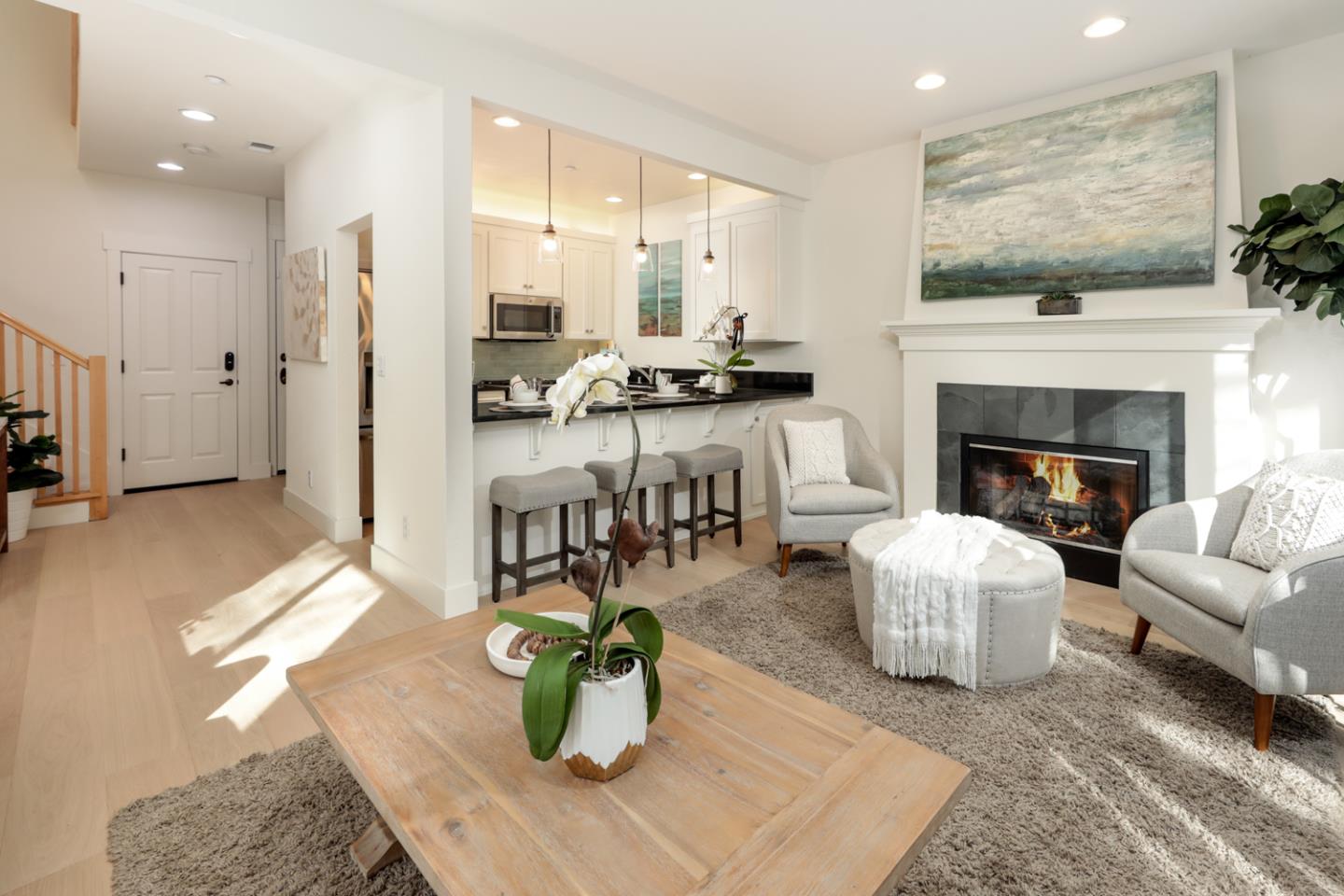 595 Willow Road Menlo Park, CA 94025 - Photo 10 of 28 a living room with furniture a fireplace and a flat screen tv