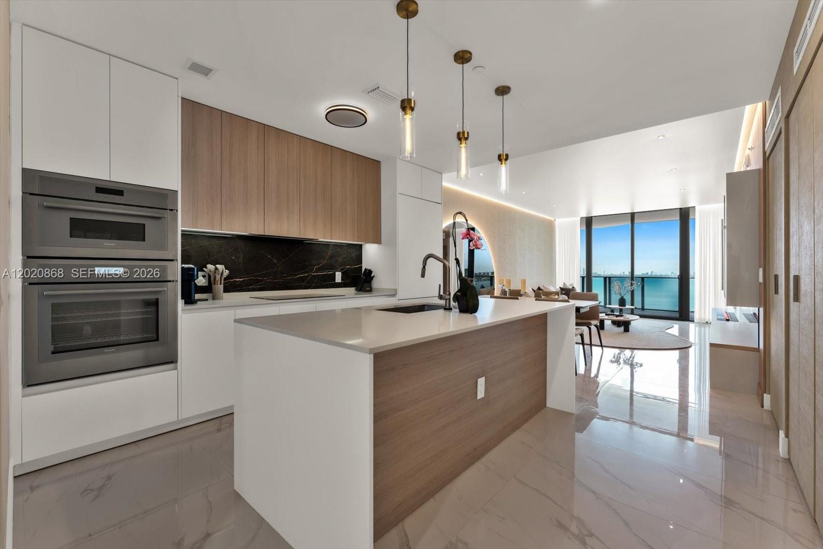 700 Northeast 24th Street, Unit 1602 Miami, FL 33137 - Photo 14 of 30 a kitchen with counter top space and stainless steel appliances