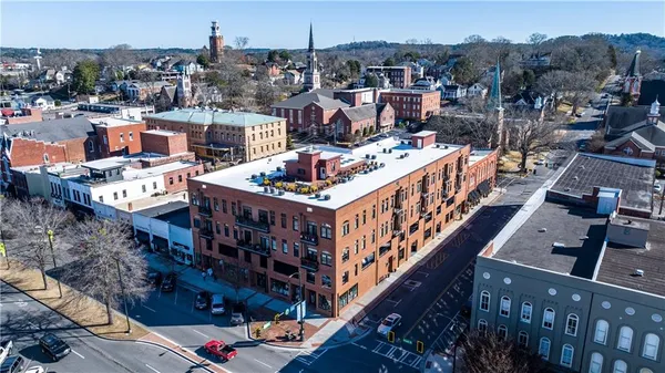 a kitchen with granite countertop a stove a sink and a refrigerator
