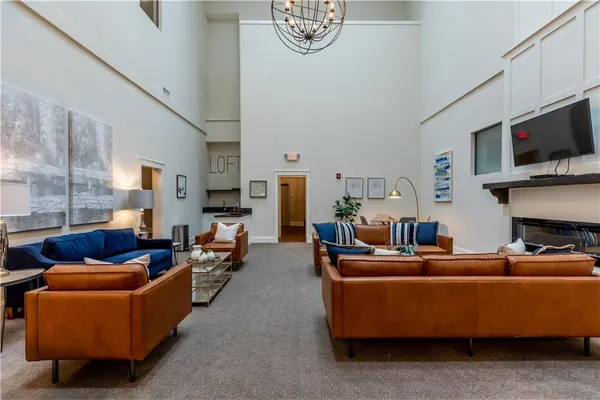 a living room with furniture a flat screen tv and a fireplace