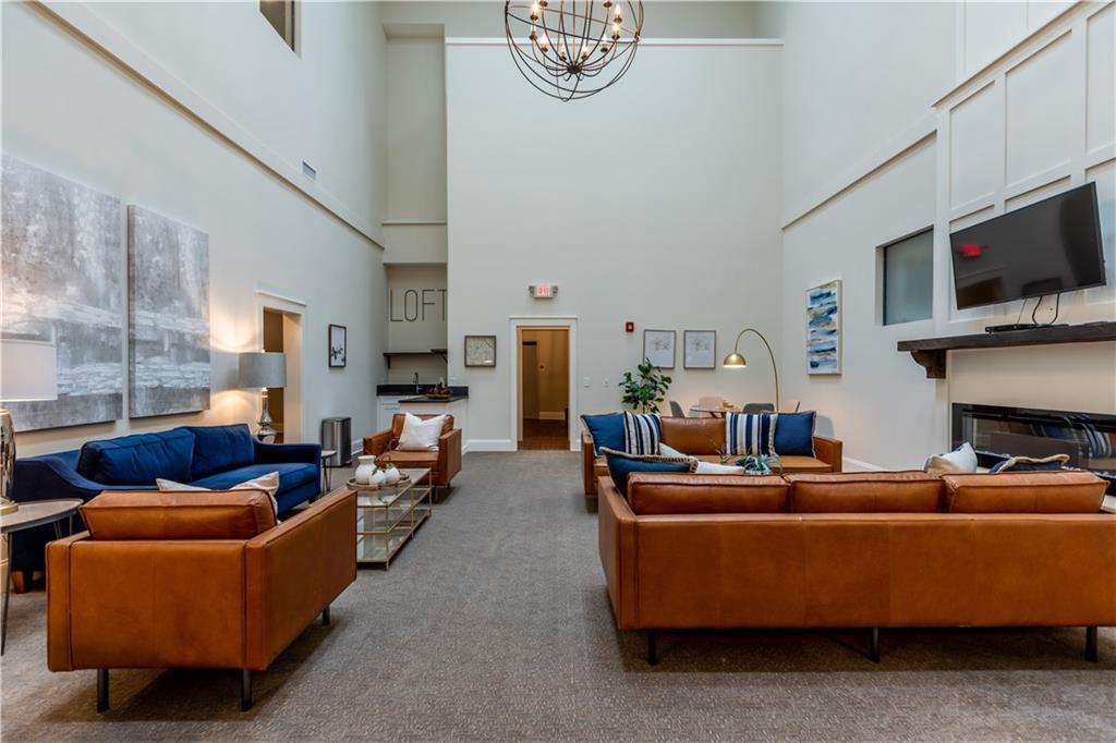 1 East 3rd Avenue, Unit 302 Rome, GA 30161 - Photo 21 of 36 a living room with fireplace furniture and a flat screen tv