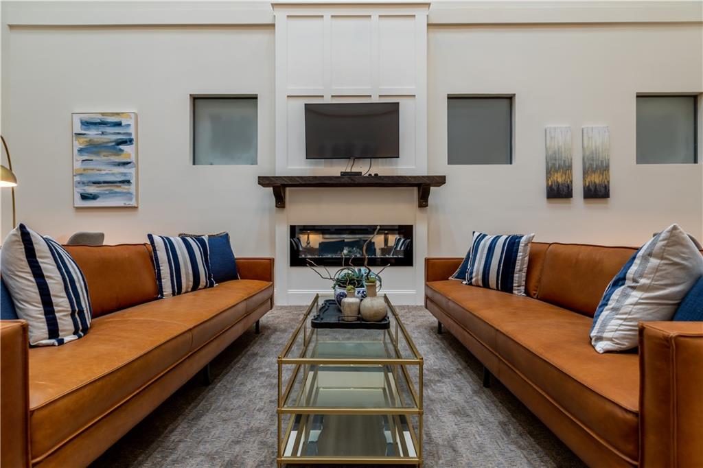 1 East 3rd Avenue, Unit 302 Rome, GA 30161 - Photo 22 of 36 a living room with furniture a flat screen tv and a fireplace