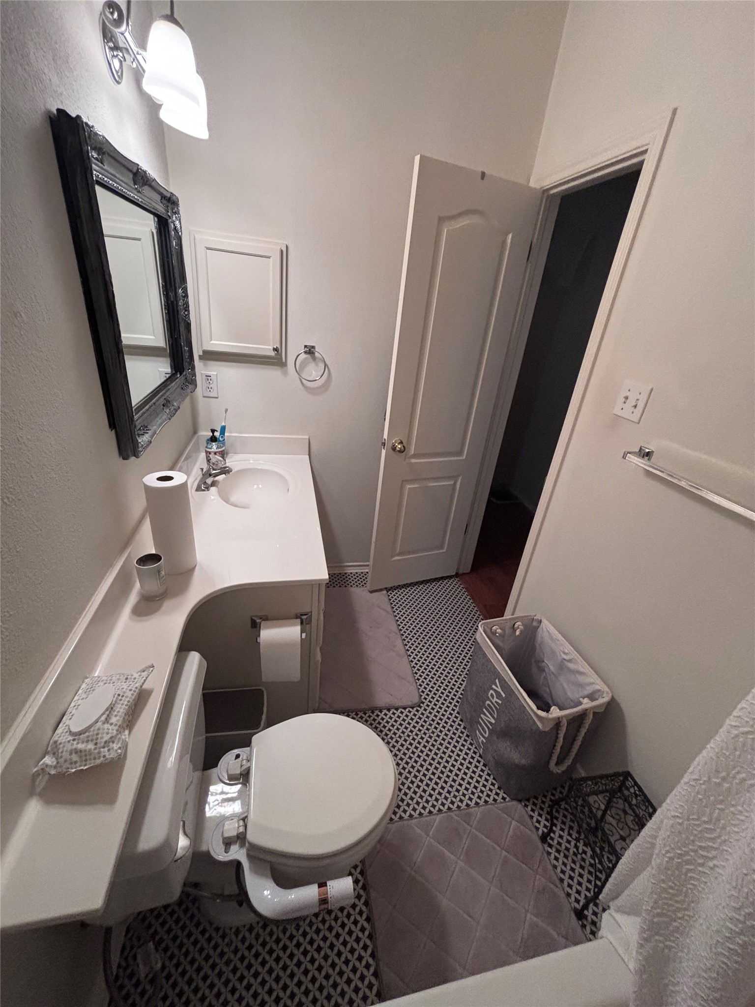 1316 Mesquite Road Cedar Park, TX 78613 - Photo 7 of 24 A compact and functional bathroom features a single vanity, a toilet, and patterned floor tiles.
