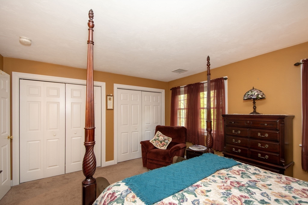53 Hemlock Circle, Unit 53 Hanover, MA 02339 - Photo 16 of 27 a bed room with a bed and a dresser