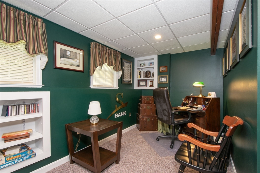 53 Hemlock Circle, Unit 53 Hanover, MA 02339 - Photo 20 of 27 a living room with furniture and a bookshelf